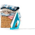 Electric iron and pile of clothes.